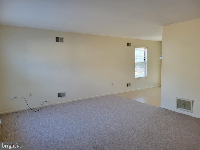 empty room featuring light carpet and visible vents