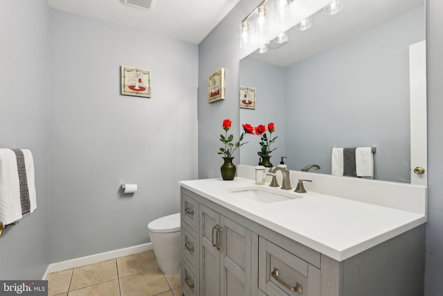 half bathroom featuring visible vents, baseboards, toilet, tile patterned floors, and vanity