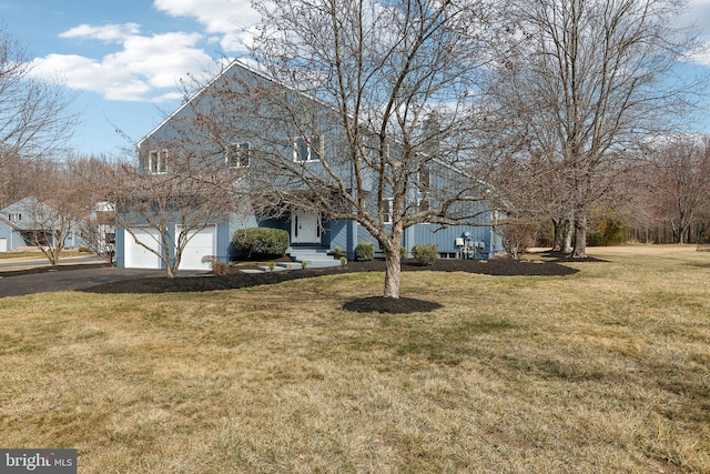 exterior space featuring aphalt driveway, a yard, and an attached garage