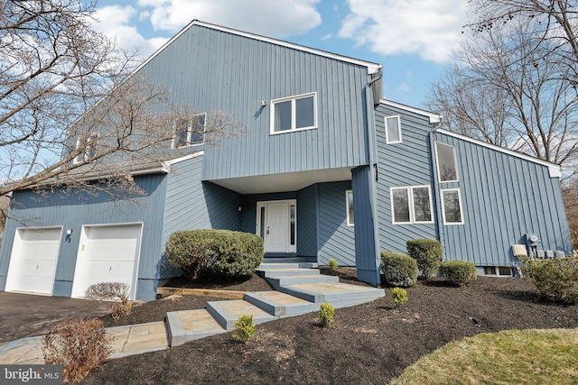 view of front of home featuring aphalt driveway and an attached garage