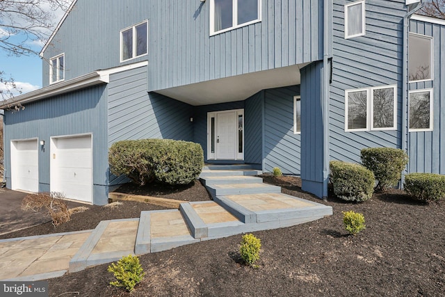 view of exterior entry featuring an attached garage