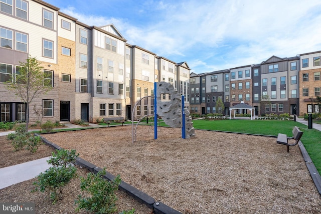 view of property's community with a residential view, playground community, a yard, and a gazebo