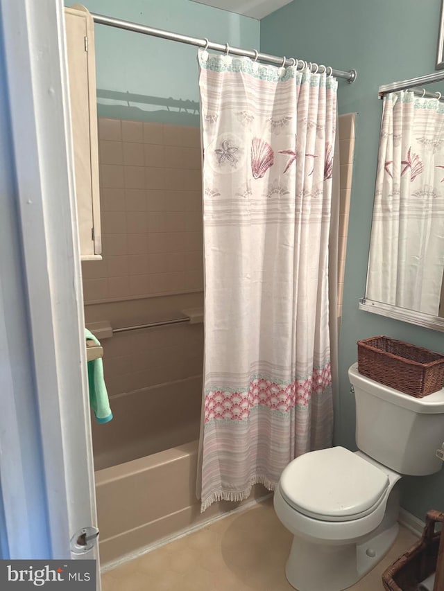 full bathroom with shower / bath combo with shower curtain, toilet, and tile patterned floors