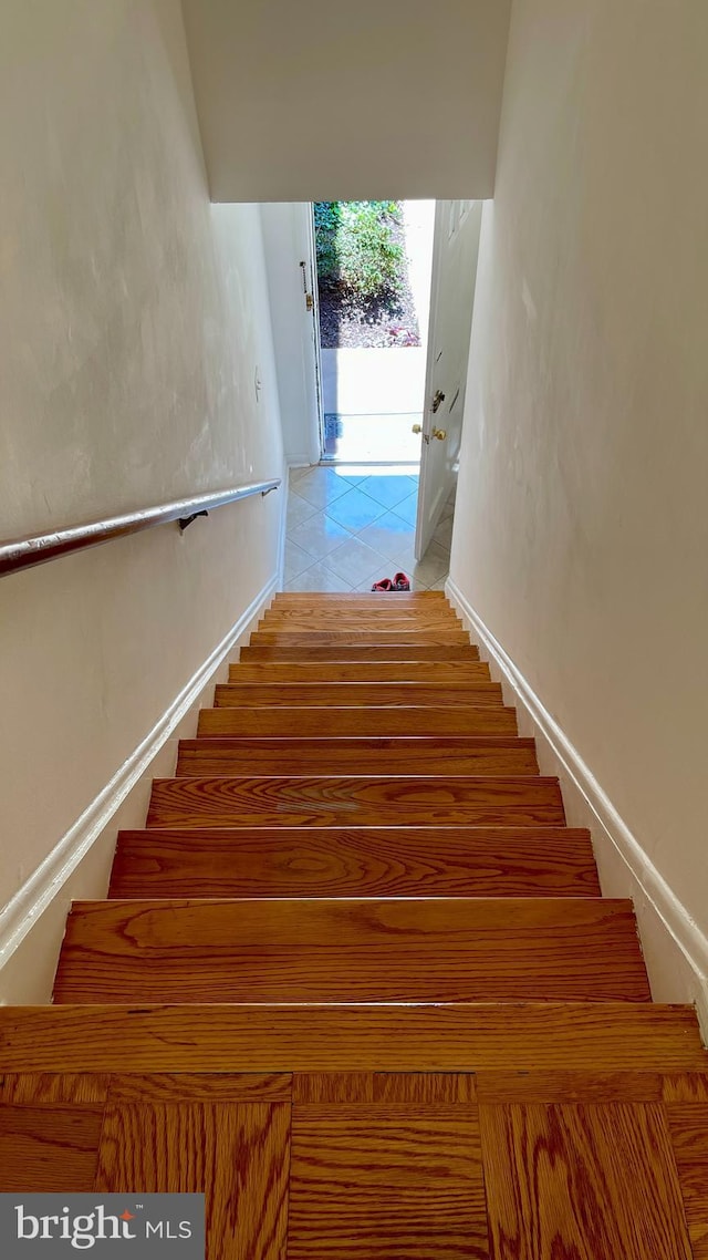 stairway with tile patterned flooring