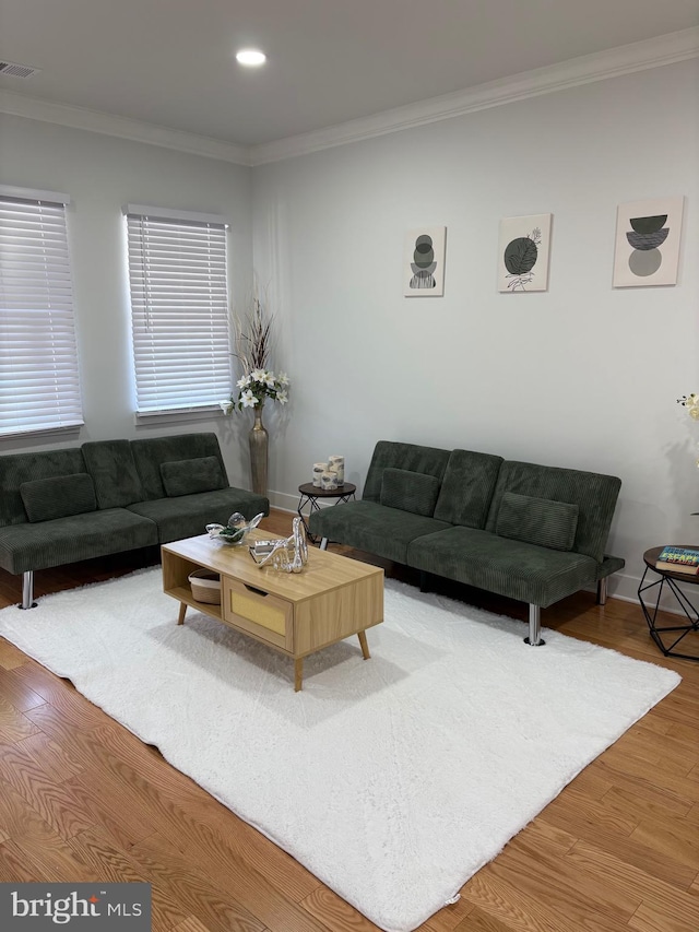 living area featuring recessed lighting, visible vents, crown molding, and wood finished floors