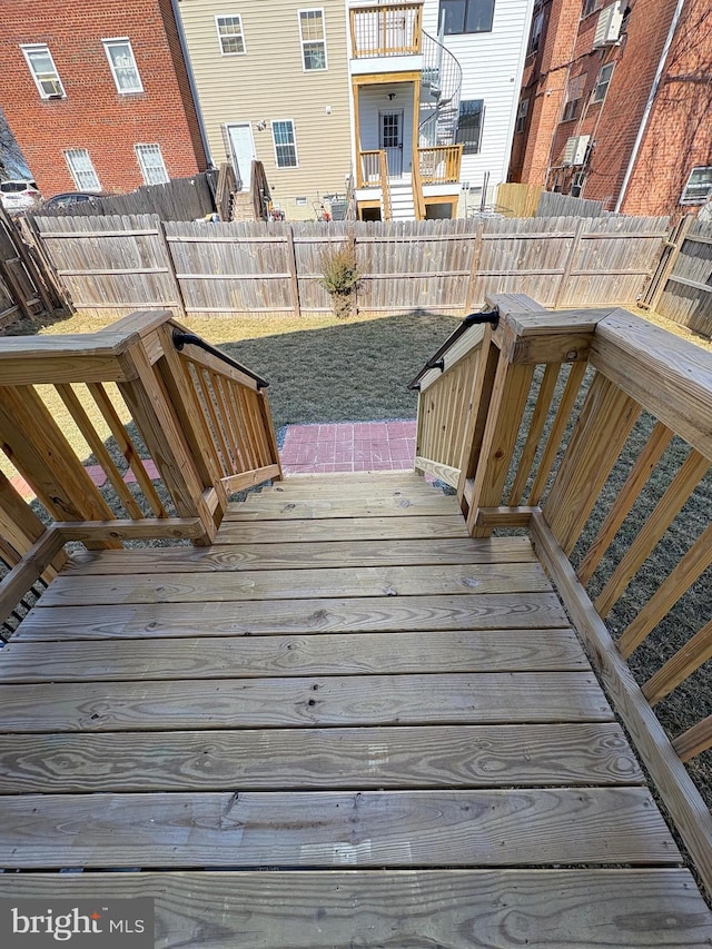 wooden deck featuring a fenced backyard