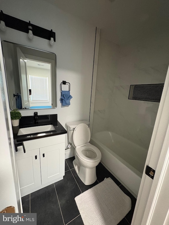 bathroom with toilet, tile patterned floors, and vanity