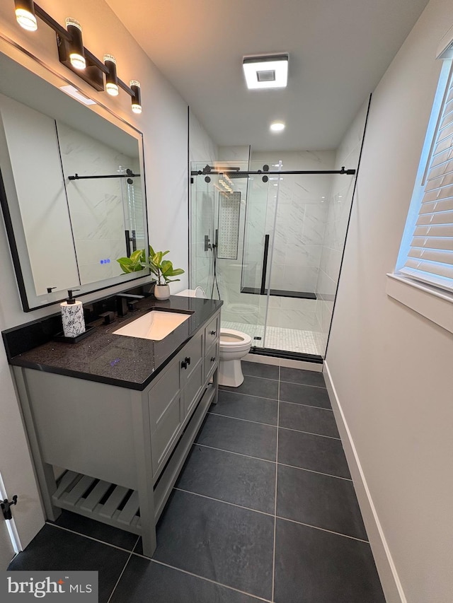 full bathroom with toilet, vanity, baseboards, a shower stall, and tile patterned floors