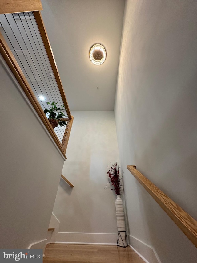 stairs featuring baseboards and wood finished floors