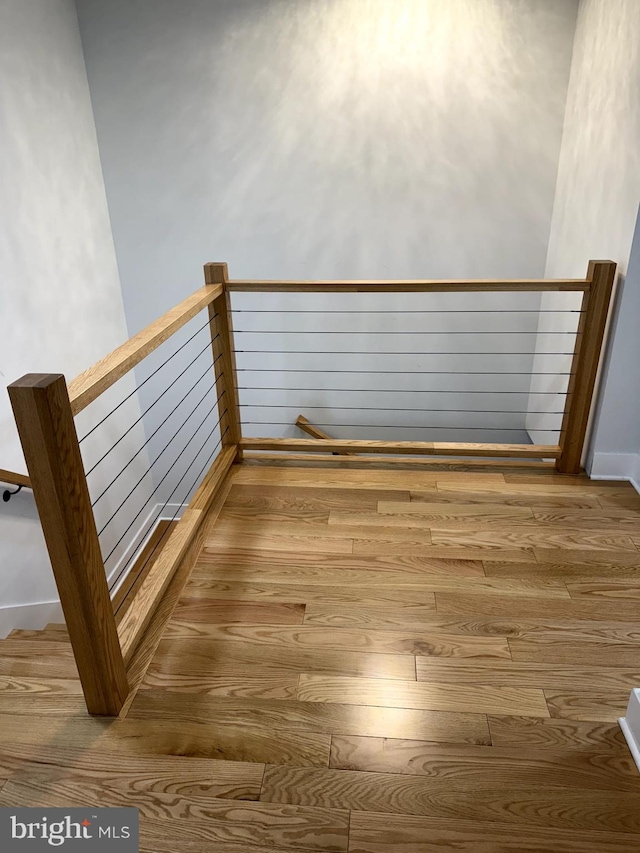 interior space with an upstairs landing and wood finished floors