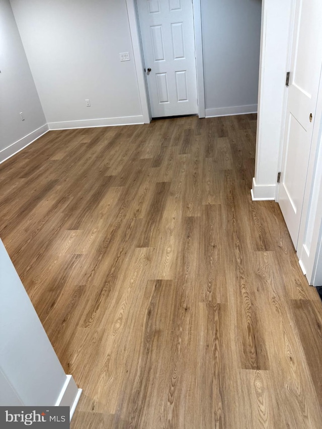 interior space featuring baseboards and wood finished floors