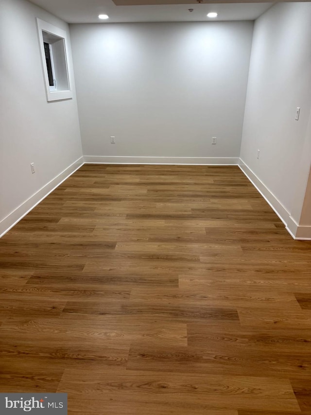 basement featuring recessed lighting, baseboards, and wood finished floors