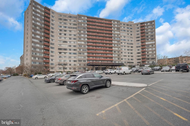 view of building exterior featuring uncovered parking