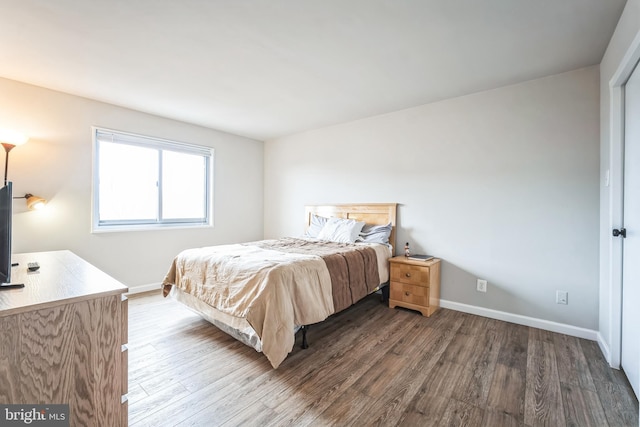 bedroom featuring baseboards and wood finished floors