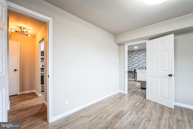 interior space featuring light wood-style floors and baseboards