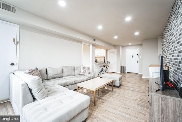 living area with recessed lighting, light wood-style floors, and visible vents