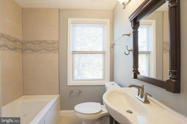 full bathroom with a sink, toilet, and baseboards