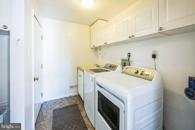 washroom featuring visible vents, baseboards, cabinet space, independent washer and dryer, and a sink