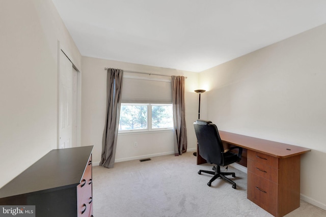 office space featuring visible vents, baseboards, and light colored carpet