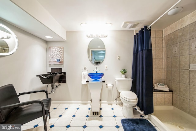 bathroom with visible vents, a shower stall, toilet, and baseboards