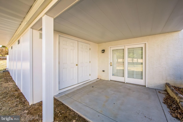 property entrance featuring a patio area and stucco siding