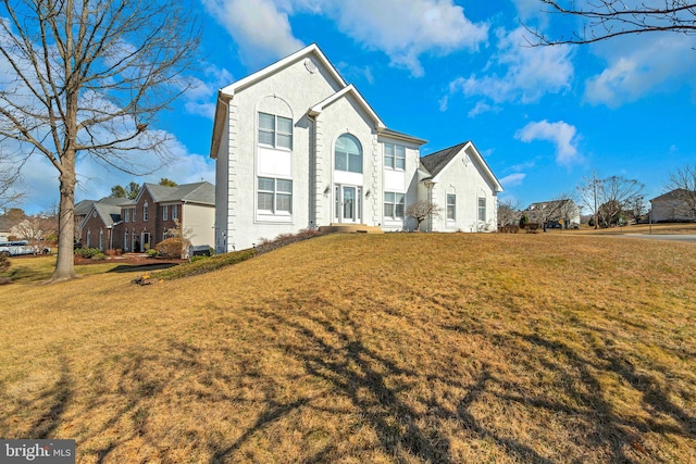 view of front of property featuring a residential view and a front lawn