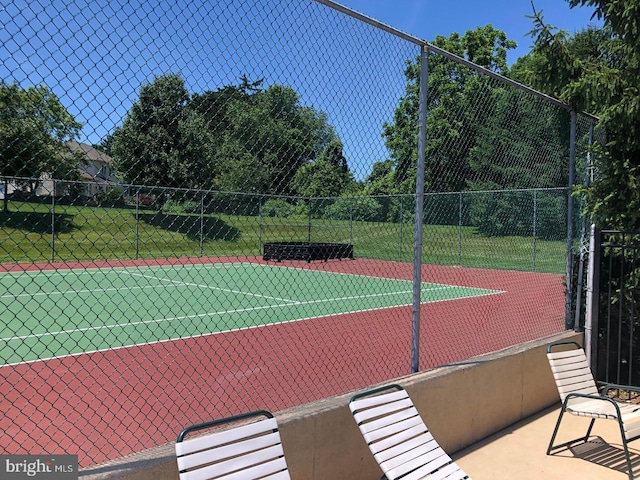 view of tennis court with fence