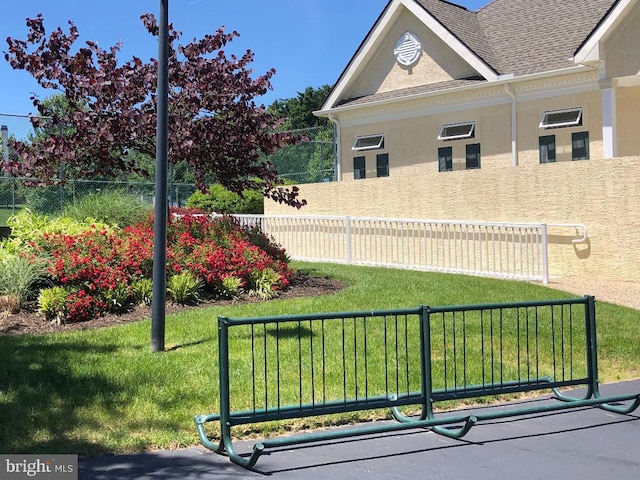 exterior space with a yard, stucco siding, and fence