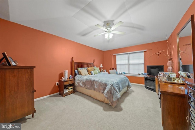 bedroom featuring ceiling fan, baseboards, and light colored carpet