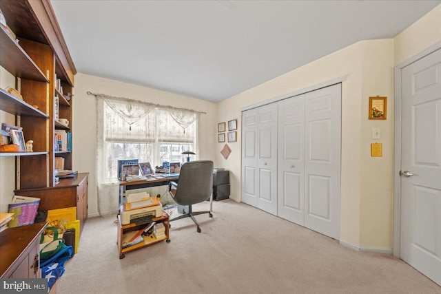 carpeted office space featuring baseboards