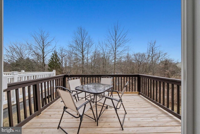 wooden terrace with outdoor dining area