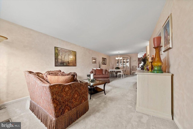 living room with a notable chandelier, baseboards, and light colored carpet