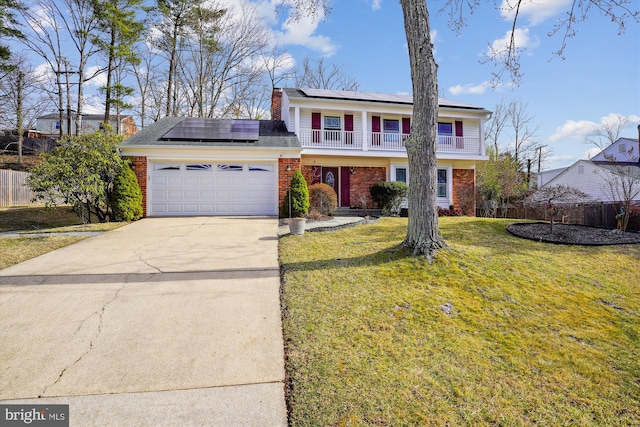 view of front of property featuring a front yard, fence, driveway, a garage, and brick siding