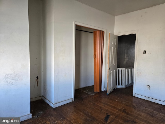 unfurnished bedroom with a closet and hardwood / wood-style floors