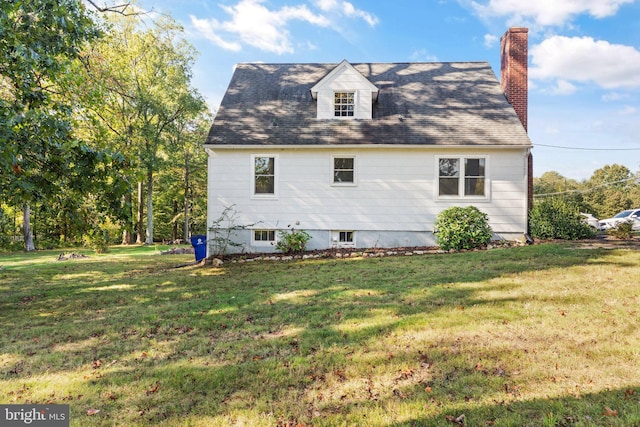 view of side of property featuring a chimney and a yard