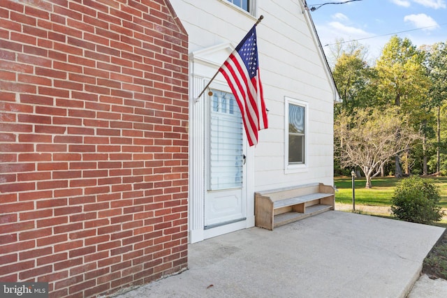 doorway to property with brick siding