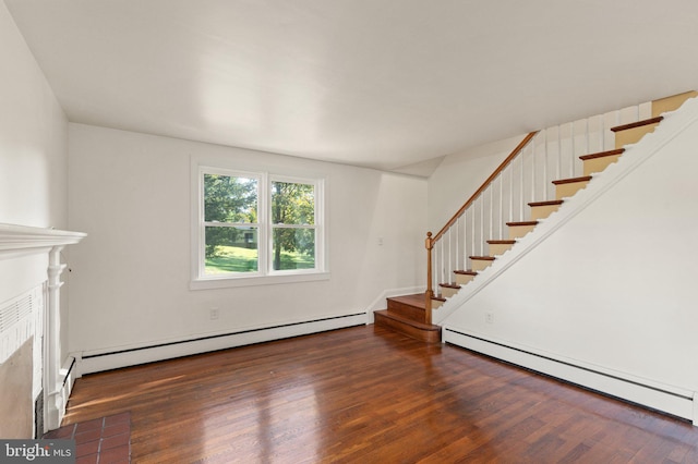 unfurnished living room with a fireplace with flush hearth, stairway, a baseboard radiator, and wood finished floors