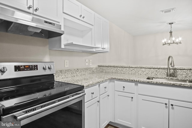 kitchen with under cabinet range hood, a sink, white cabinetry, visible vents, and stainless steel range with electric cooktop