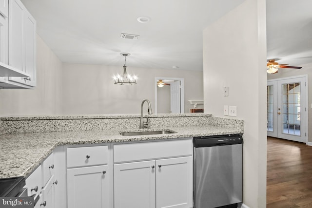 kitchen featuring light stone counters, stainless steel appliances, visible vents, white cabinets, and a sink