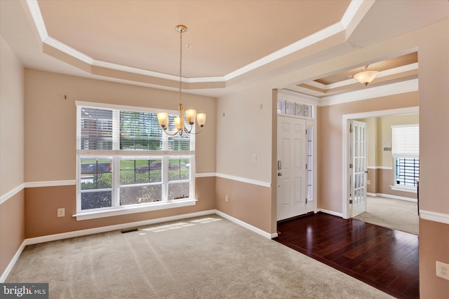13010 Davenport Dr, Brandywine, MD 20613 - unfurnished dining area with wood finished floors, ornamental molding, a tray ceiling, baseboards, and a notable chandelier
