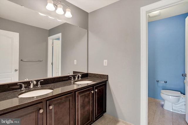 13010 Davenport Dr, Brandywine, MD 20613 - full bath with double vanity, tile patterned flooring, toilet, and a sink
