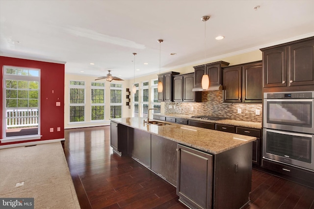 13010 Davenport Dr, Brandywine, MD 20613 - kitchen with dark wood finished floors, a sink, a center island with sink, dark brown cabinetry, and appliances with stainless steel finishes