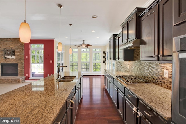 13010 Davenport Dr, Brandywine, MD 20613 - kitchen with a sink, tasteful backsplash, light stone countertops, under cabinet range hood, and appliances with stainless steel finishes