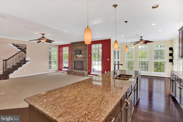 13010 Davenport Dr, Brandywine, MD 20613 - kitchen featuring a fireplace, a ceiling fan, pendant lighting, and a sink