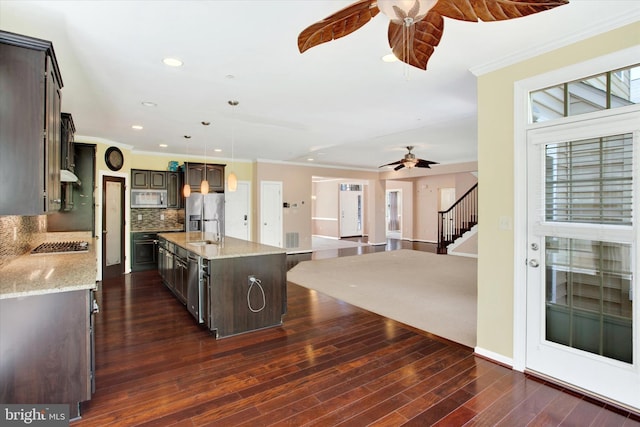 13010 Davenport Dr, Brandywine, MD 20613 - kitchen featuring dark brown cabinets, decorative backsplash, a ceiling fan, appliances with stainless steel finishes, and ornamental molding