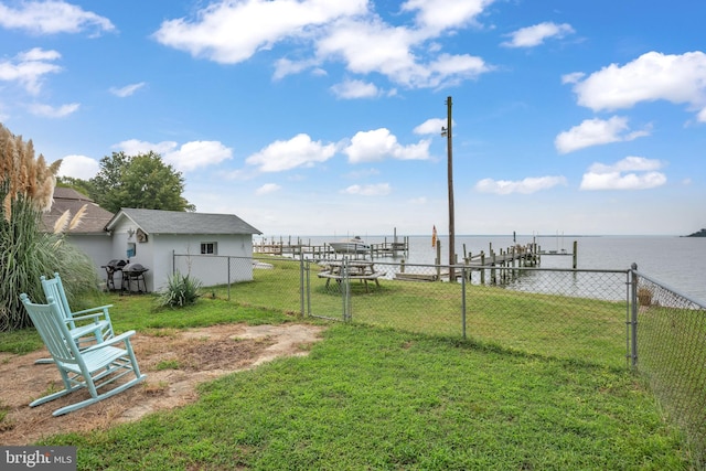 view of yard featuring a water view and fence