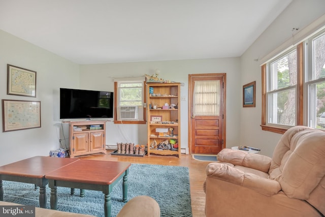 living area featuring light wood-style floors and cooling unit