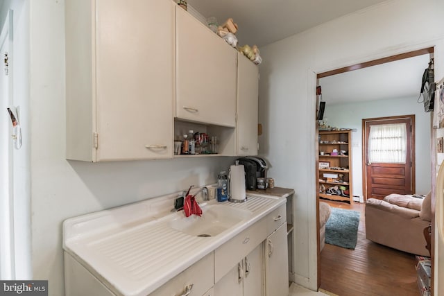 kitchen with light countertops, a sink, and light wood-style flooring