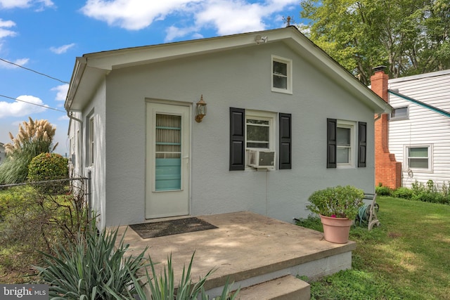 exterior space featuring a patio area, a yard, fence, and stucco siding