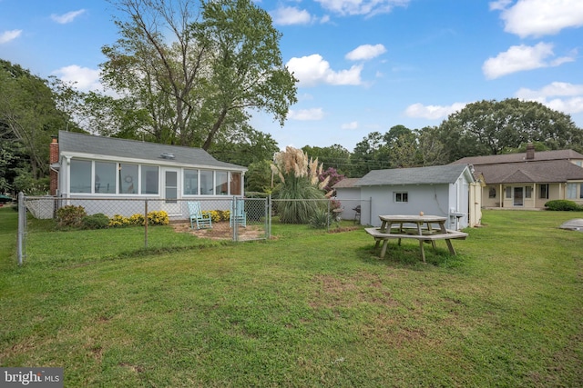 view of yard with a sunroom and fence